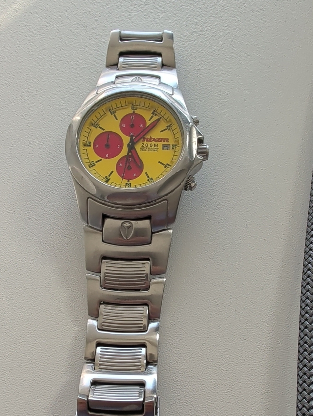 Vintage Nixon Silver Bracelet Watch with Yellow Dial and Red Subdials